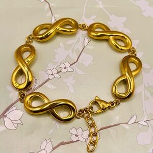 Gold Tone Infinity Link Bracelet. Stainless Steel. 7 to 8 inches long